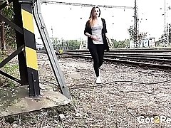 Girl takes a piss by the train tracks